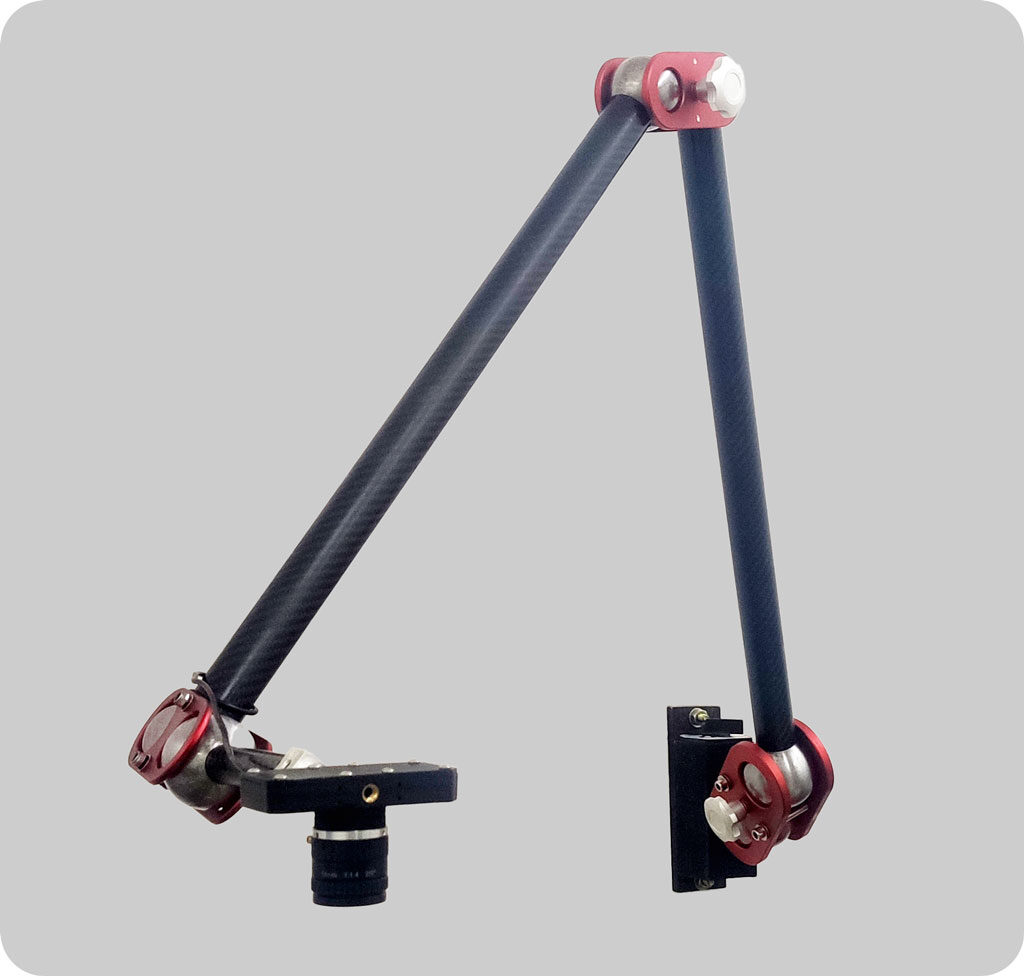 Product shot of a black two-link arm with red joints, a camera lens on a clamp at one end and a bracket at the other, on a grey background.