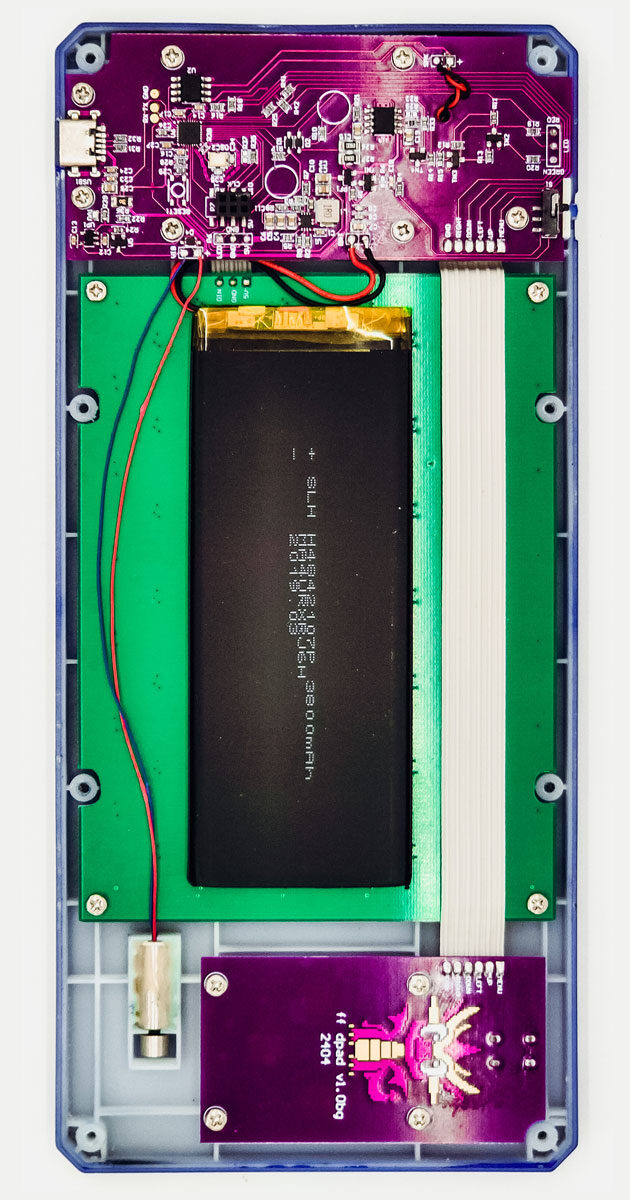 Opened handheld showing purple circuit boards and a long black battery in a clear case.